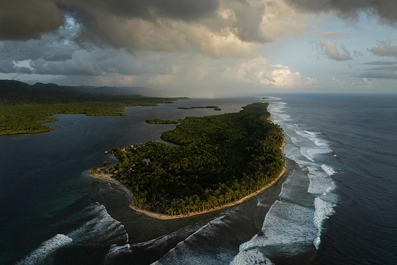 The Last Dolphin Hunters by Matthew Abbott _ Credit: © Matthew Abbott, Oculi, for The New York Times Title: The Last Dolphin HuntersCredit: © Matthew Abbott, Oculi, for The New York TimesCaption: Fanalei Island has been reduced to a narrow strip of sand and coral by rising seas. Residents believe the settlement, once home to dozens of families, will become uninhabitable in the near future. South Malaita, Solomon Islands, 6 February 2025. Story: Fanalei, a low-lying island in the Solomon Islands, stands at a crossroads between contested tradition and a changing economy. For generations, dolphin hunting provided food and income, with dolphin teeth used as ritual currency for bride-price and other forms of local exchange. Today, as rising sea levels displace the community and threaten its future, seaweed farming is providing an economic alternative to the seasonal hunt. As seaweed farming expands, fewer people are available for the collective efforts upon which dolphin hunting depends. This story captures a community reshaped by environmental pressure and shifting traditions.