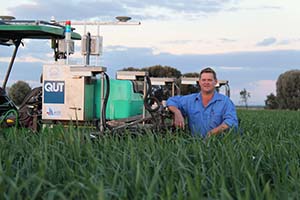 Andrew Bate with the QUT agricultural robot testbed.